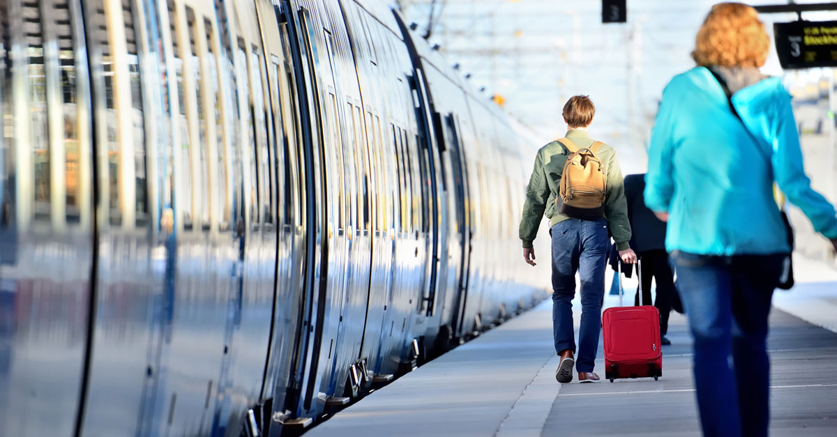 Resenärer skyndar fram på perrongen till ett väntande tåg - regional kollektivtrafik